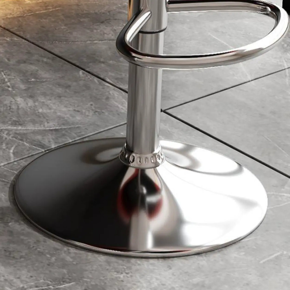 Close-up of silver pedestal base and oval metal footrest on the adjustable bar stool