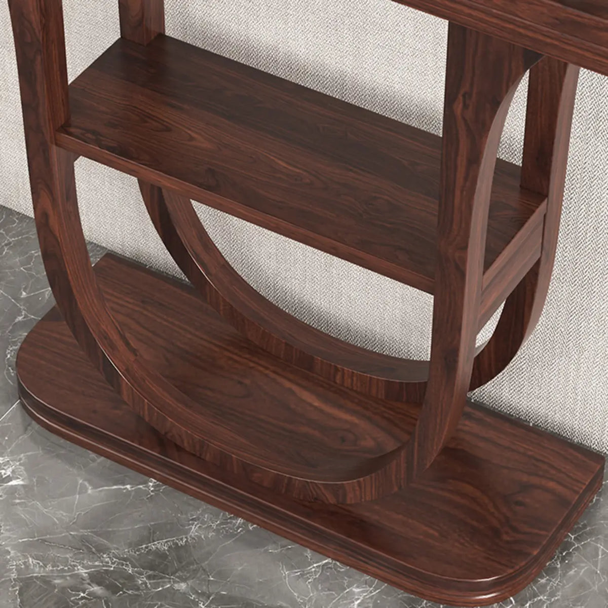 Close-up of the lower shelf joinery on a wood demilune console table with a curved U-shaped base