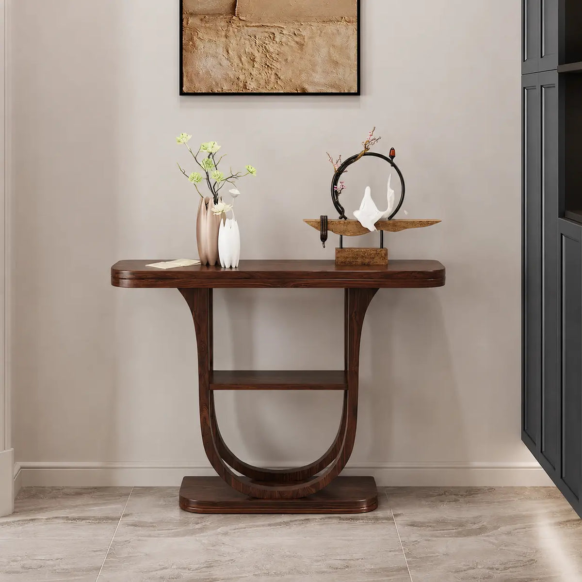 Narrow wood entryway table with curved demilune top and U-shaped legs, front view beside dark cabinetry