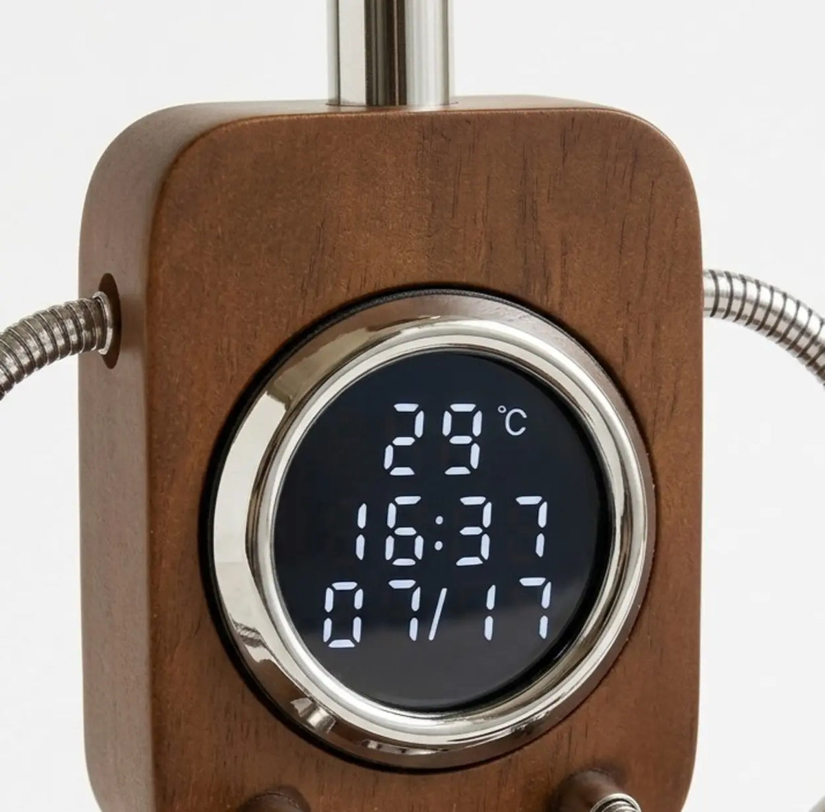 Close-up of digital clock and room temperature display on a walnut table lamp