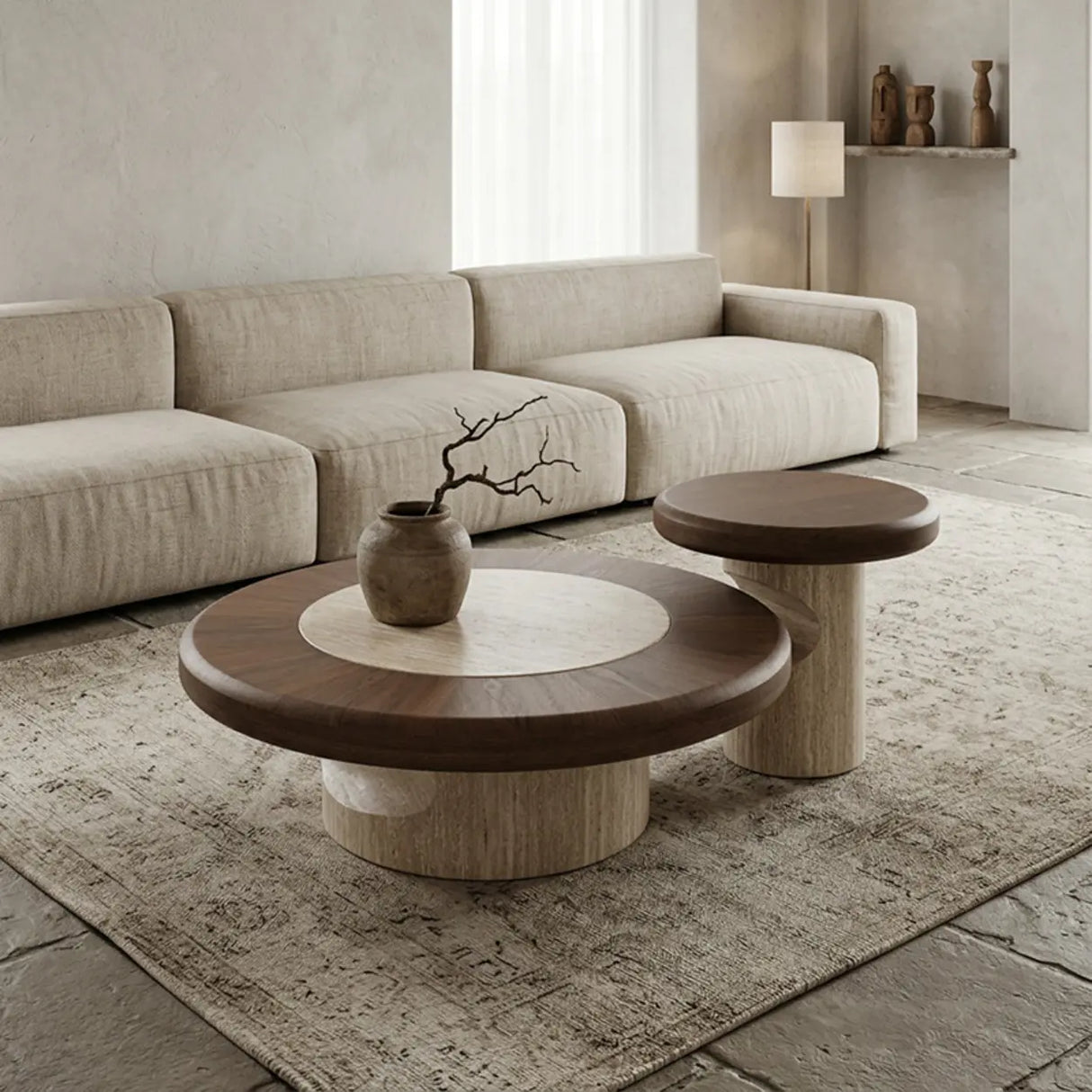 Walnut round coffee table set with large and small tables, warm wood tops and sculptural stone bases arranged on a neutral rug