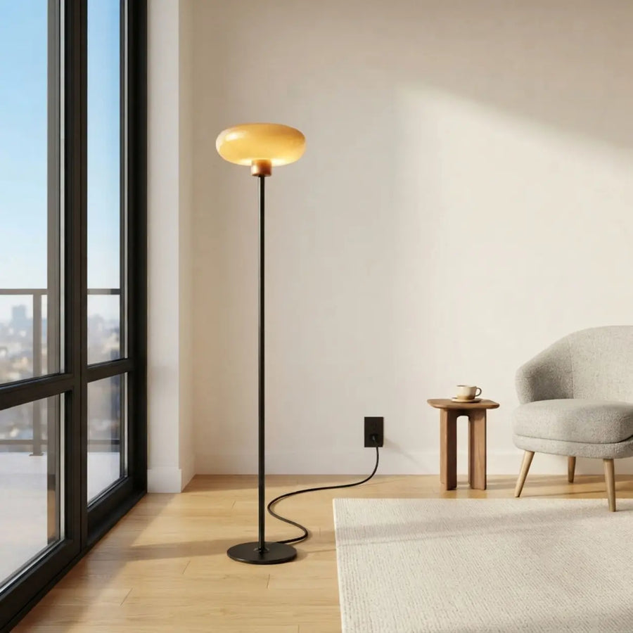 Tall black LED floor lamp with amber glass shade for a living room