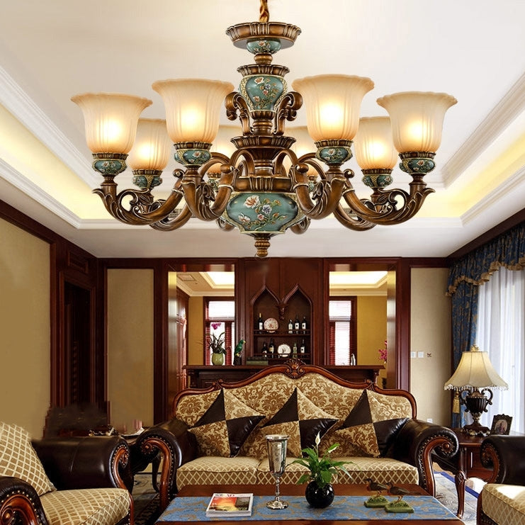 Traditional ceramic dining room chandelier with frosted flower glass shades and warm light