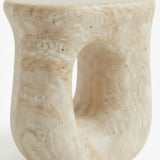 Faux travertine stone side table close-up showing the hollow curved base and detailed travertine texture