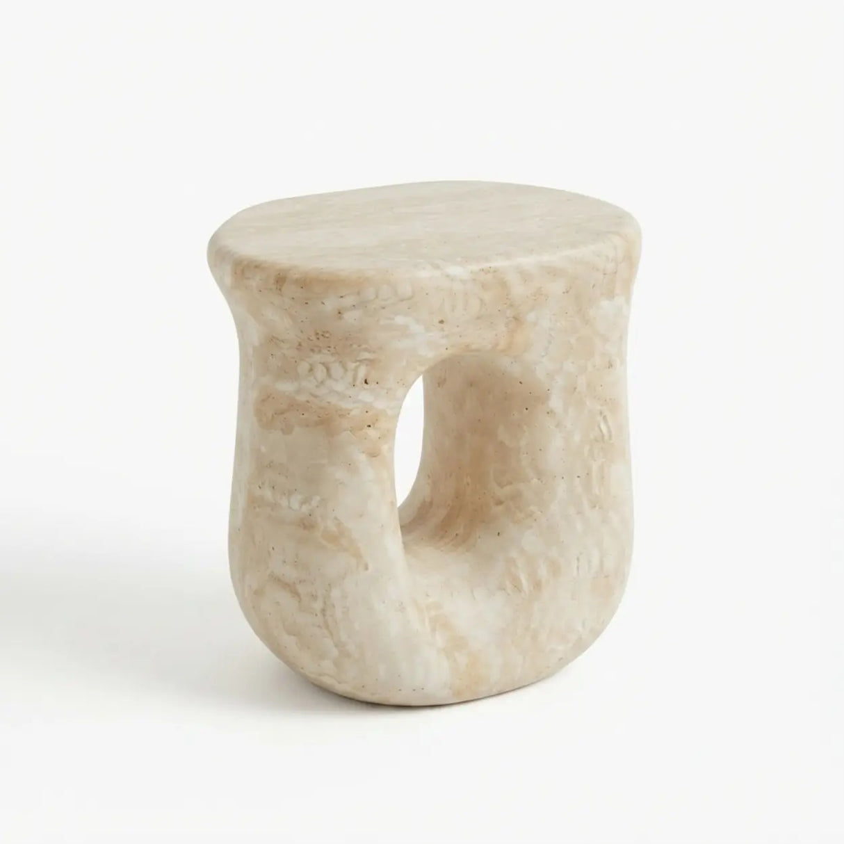 Faux travertine stone oval side table with a rounded top and hollow curved base isolated on a white background