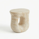 Faux travertine stone oval side table with a rounded top and hollow curved base isolated on a white background