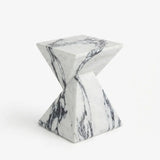 White veined faux stone side table with a twisted geometric pedestal isolated on a white background