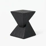 Black faux travertine stone side table with a twisted geometric pedestal isolated on a white background