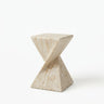 Travertine faux stone side table with a rounded square top and twisted geometric pedestal isolated on a white background