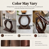 Dark bronze half circle console table with white sintered stone top in a modern hallway with fluted wall