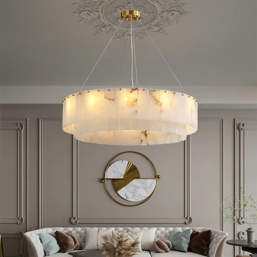 Luxury tiered brass and alabaster circular chandelier illuminating a warm modern room