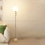 Minimalist Stacked Green Accents and Globe Floor Lamp Image - 8
