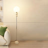 Minimalist Stacked Green Accents and Globe Floor Lamp Image - 8