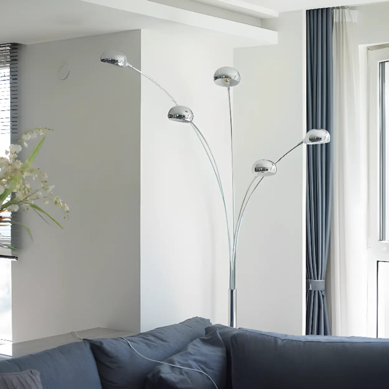 Modern arched floor lamp beside sofa in contemporary living room