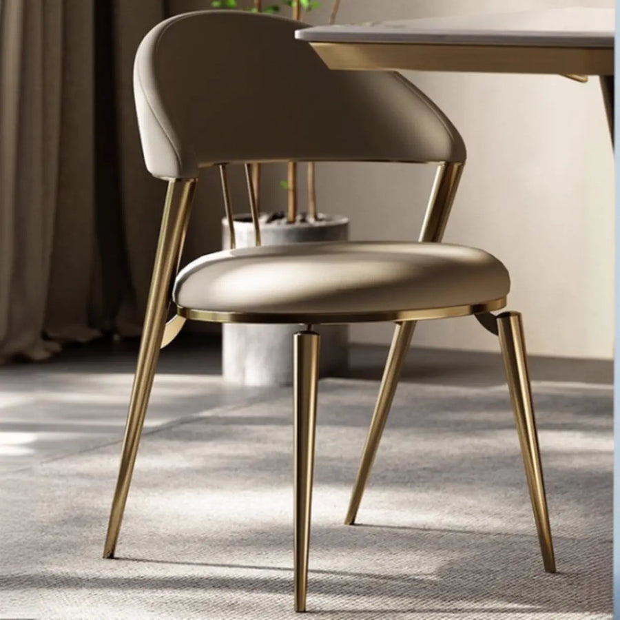 Modern faux leather upholstered dining chair with curved ergonomic back and metal legs