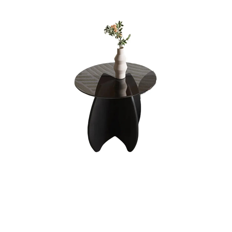 Small round gray glass coffee table with a sculptural wood base