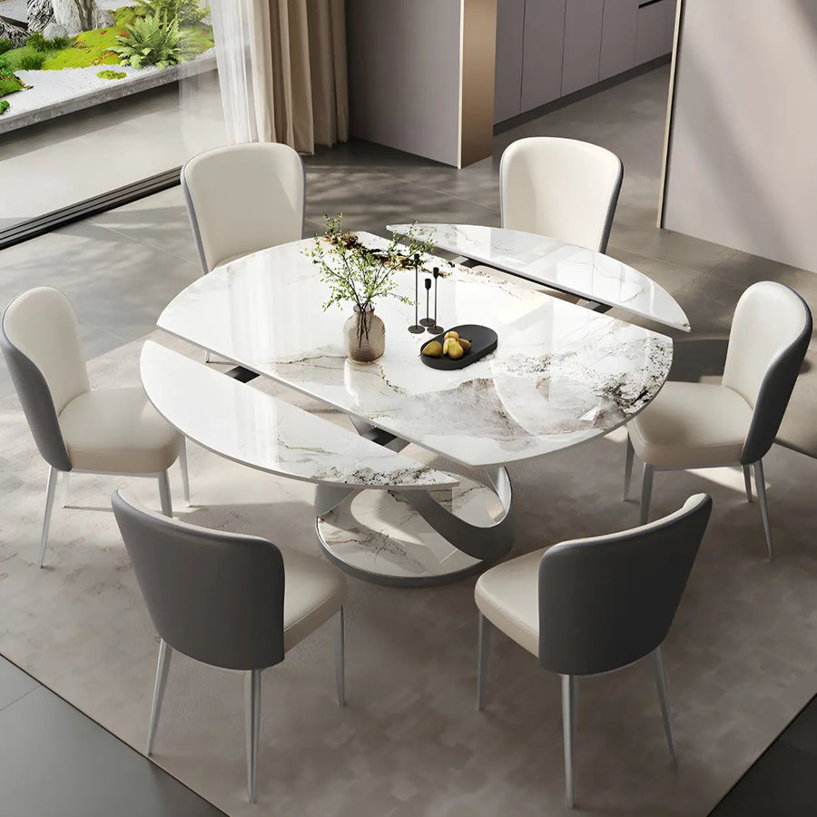 White round stone extendable dining table with pedestal base and dining chairs