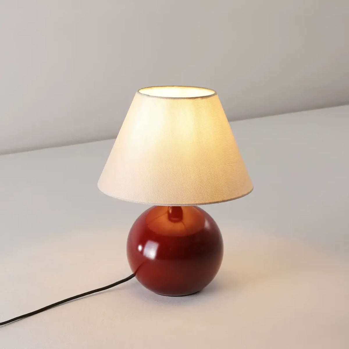 Red Ceramic Table Lamp with Beige Fabric Drum Shade Image - 3