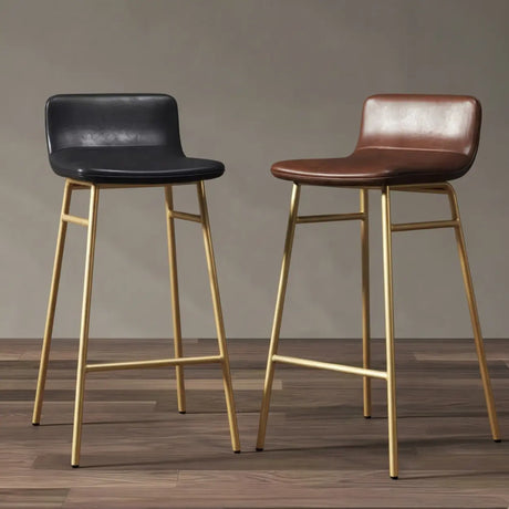 Black and brown faux leather bar stools with gold metal frames, low backrests and integrated footrests