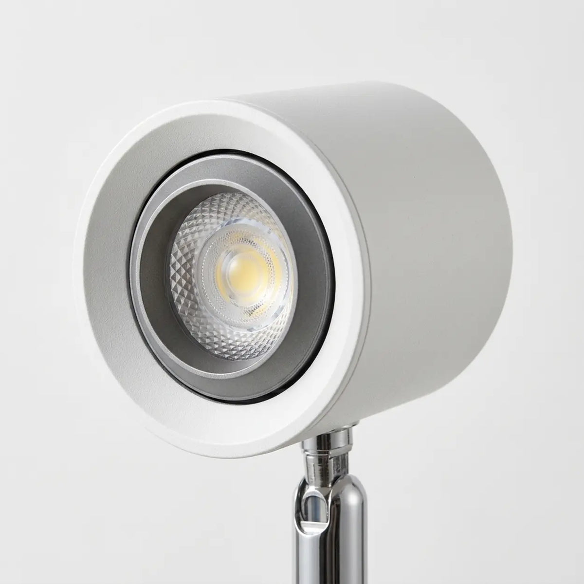 Close-up of the LED light head on a walnut wood desk lamp