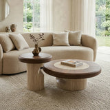 Two-piece walnut round coffee table set with a large coffee table and matching side table, wood-veneer tops, cream stone inlay and curved stone bases in a bright living room