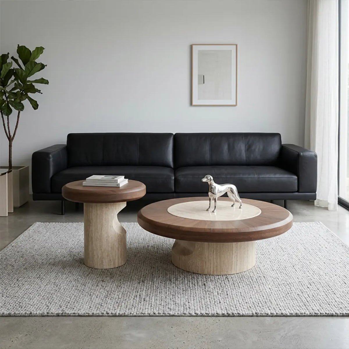 Walnut round coffee table set with large and small wood-veneer tables, cream stone inlay and curved stone bases in front of a black sofa